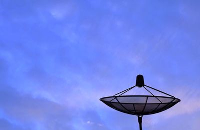 Low angle view of communications tower against blue sky