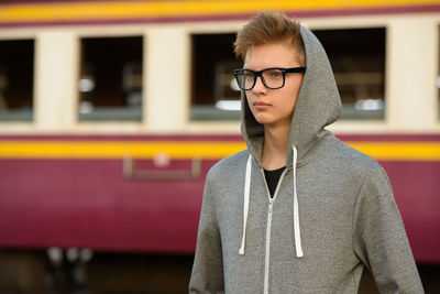 Portrait of young man standing outdoors