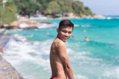 Portrait of shirtless man at beach