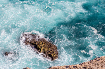 High angle view of rocks in sea