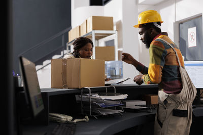 Rear view of man working at office