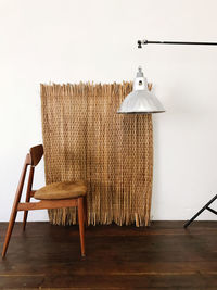 Empty chair on table against wall at home