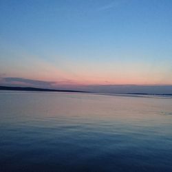 Scenic view of lake against blue sky during sunset