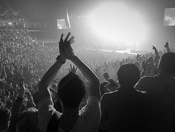 Crowd with arms raised in concert