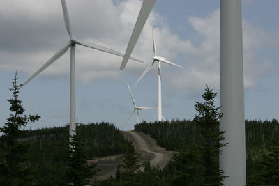 Windmills against sky