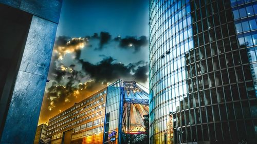 Low angle view of modern buildings against sky at dusk