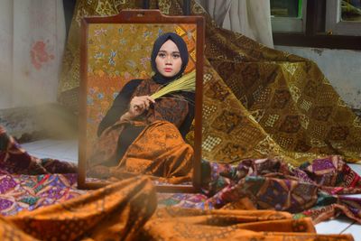 Portrait of woman sitting in temple