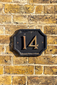 House number 14 on a brick wall in london