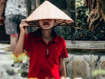 Mid adult woman wearing hat standing outdoors