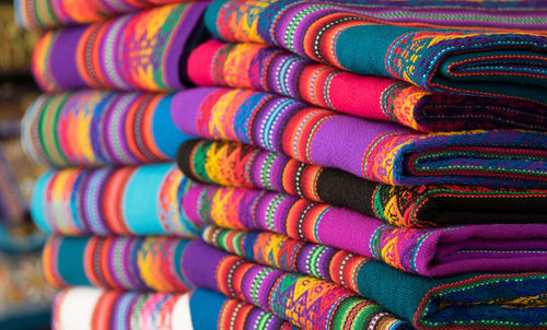 Close-up of colorful folded textiles for sale in store