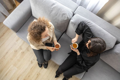 High angle view of mother and daughter on bed at home