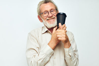 Portrait of senior man holding coffee cup