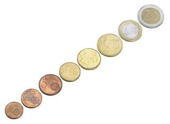 High angle view of coins on white background