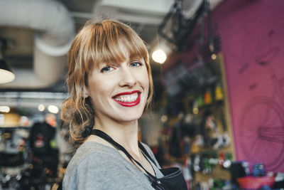 Portrait of happy female mechanic in repair shop