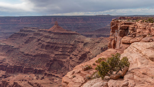 Rugged beauty of red sandstone cliffs of canyon with valley below evokes the old west
