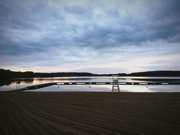 View of beach against cloudy sky