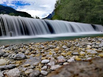 Scenic view of waterfall against rocks