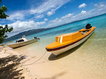 View of boats on beach against sky