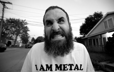 Close-up portrait of angry bearded mature man