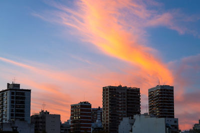 Low angle view of buildings against sky during sunset