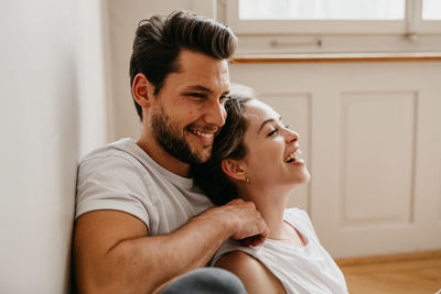 Man and woman holding hands at home