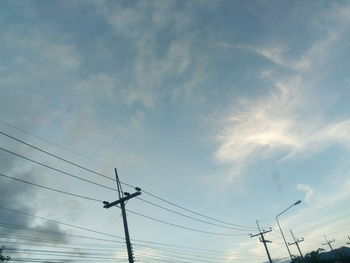 Low angle view of electricity pylon against sky