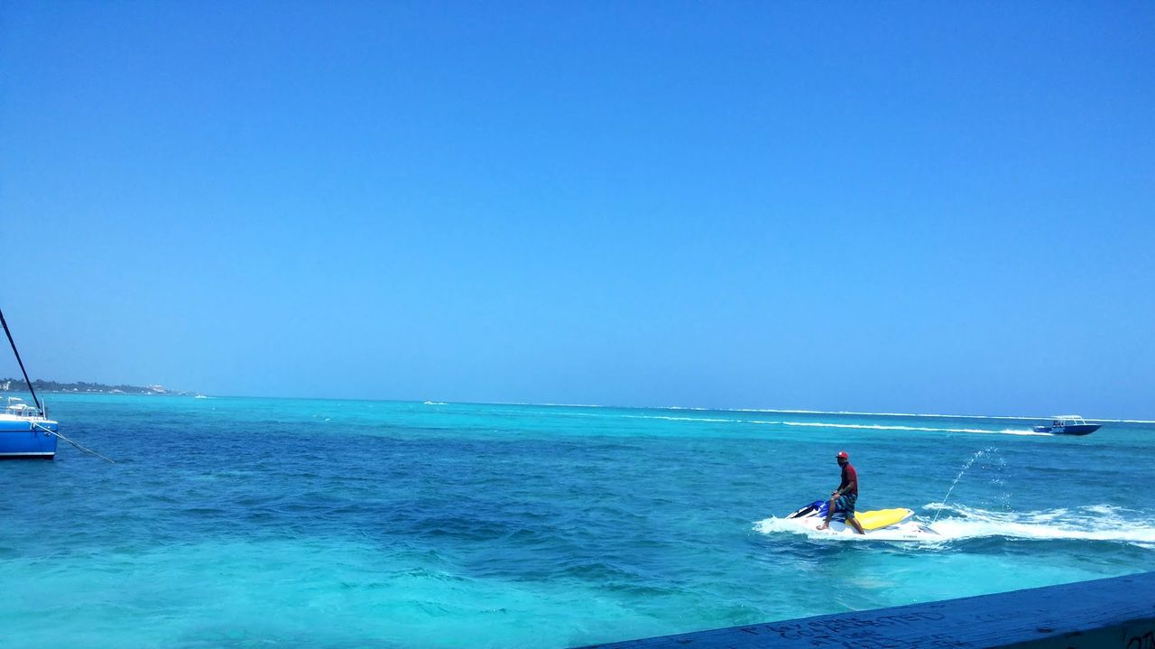 water, sea, nautical vessel, transportation, blue, clear sky, mode of transport, boat, copy space, horizon over water, leisure activity, lifestyles, men, scenics, travel, nature, vacations, waterfront, sailing