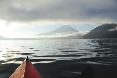 Scenic view of sea and mountains against sky