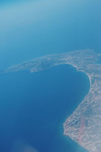 Aerial view of mountain against blue sky