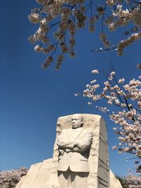 Low angle view of statue against clear blue sky