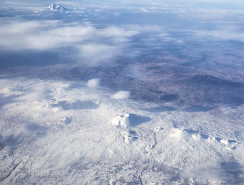 Aerial view of snowcapped mountains against sky