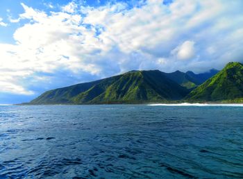 Scenic view of sea and mountains against sky