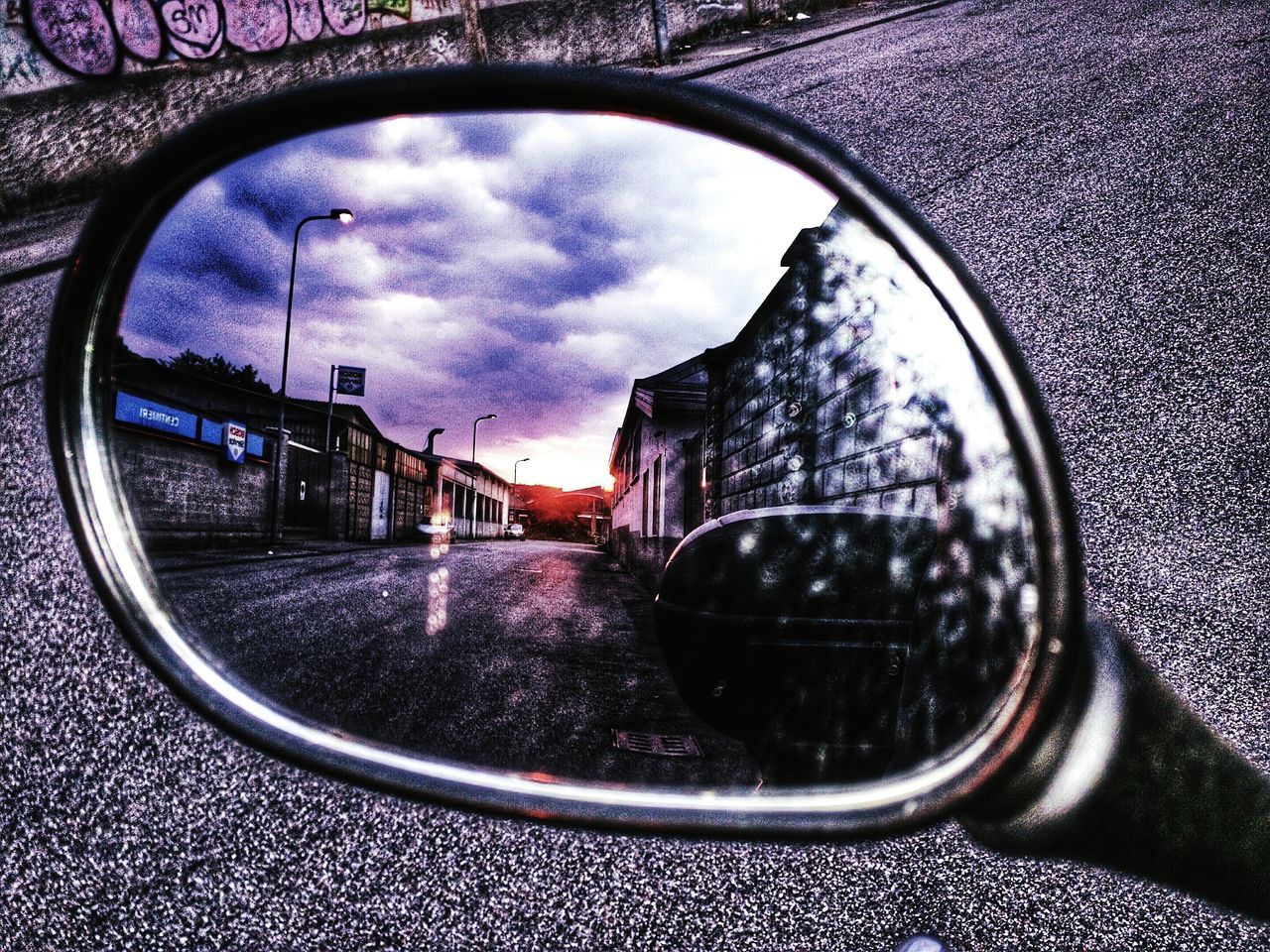 sky, glass - material, reflection, transparent, cloud - sky, water, window, wet, circle, rain, building exterior, built structure, architecture, transportation, street, car, close-up, weather, drop, cloud