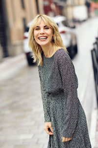 Portrait of smiling young woman in city