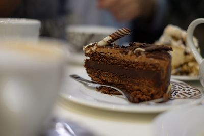 Close-up of chocolate cake slice served in plate on table