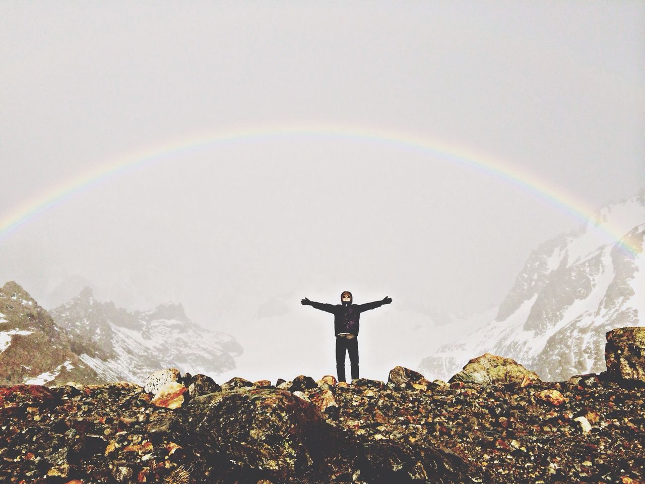 lifestyles, leisure activity, standing, full length, men, rock - object, scenics, rear view, mountain, beauty in nature, tranquil scene, nature, tranquility, sky, landscape, person, casual clothing, getting away from it all