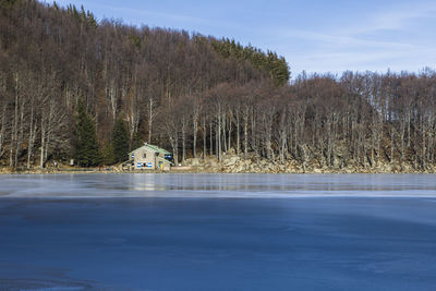 Scenic view of lake against sky during winter