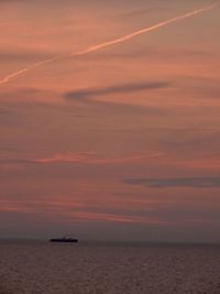 Scenic view of sea against orange sky