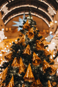 Golden christmas tree decorated with interesting decorations. magic details, festive background