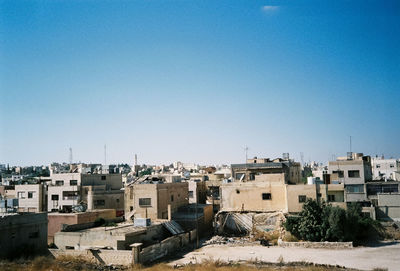 Cityscape against clear blue sky