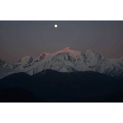 Scenic view of mountains against clear sky at night