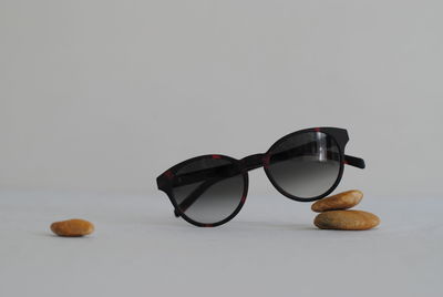 Close-up of sunglasses on table against white background