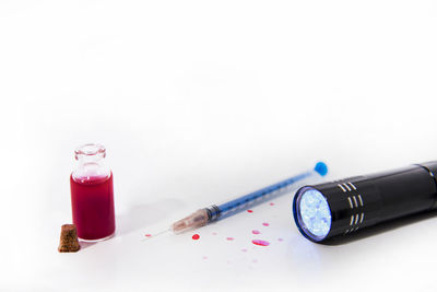 High angle view of pink bottles on table