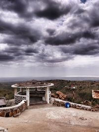 Abandoned building against cloudy sky