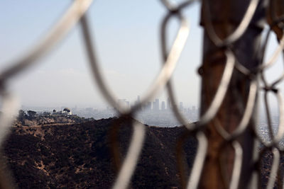 Close-up of chainlink fence against sky