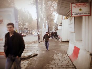 People walking on street in city