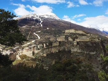 Mountain range against cloudy sky