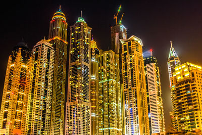 Low angle view of illuminated city at night