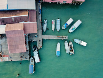 Aerial view of boats by pier in sea