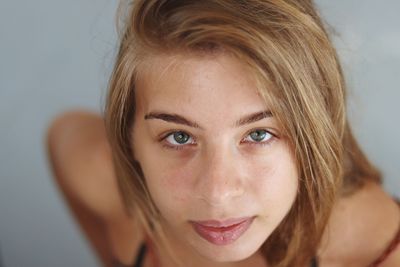 Close-up portrait of young woman with blond hair